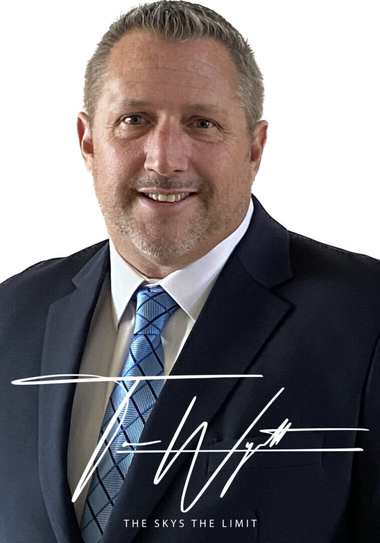 Man in suit with signature overlay.